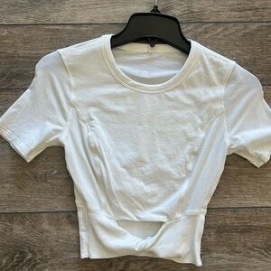 Cropped twist top w/waist cutout. Fitted short sleeved,crew neck w/logo on back.